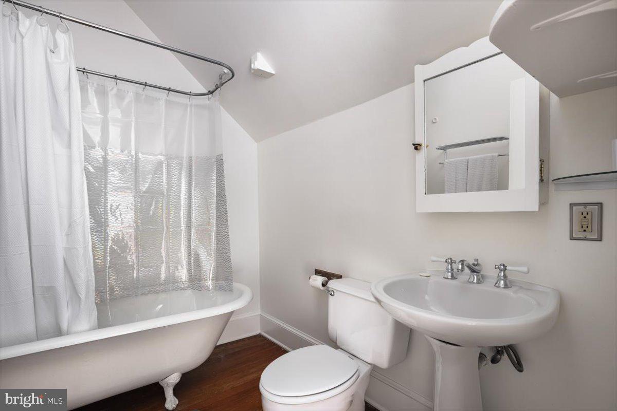 202 South Washington Street Winchester, VA 22601 - Photo 53 of 71 a bathroom with a sink toilet a mirror and shower