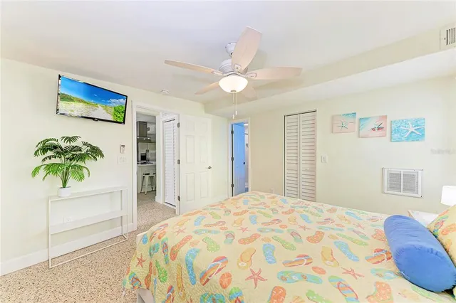 a bedroom with a bed and a potted plant