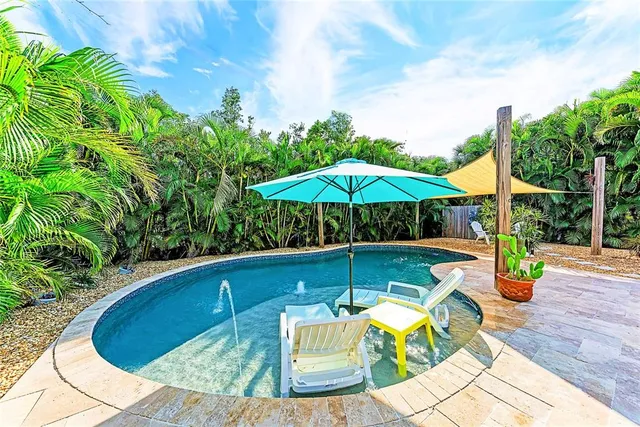 a view of swimming pool with sitting area