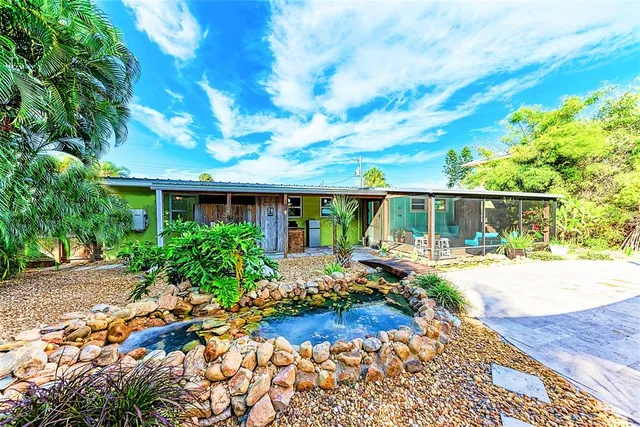 a front view of house with yard and sitting space