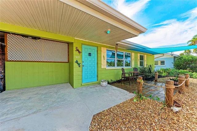 a view of a backyard with table and chairs with wooden fence