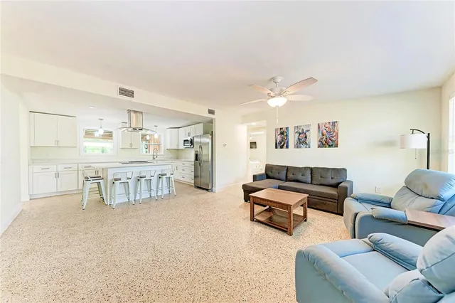 a living room with furniture and a kitchen view