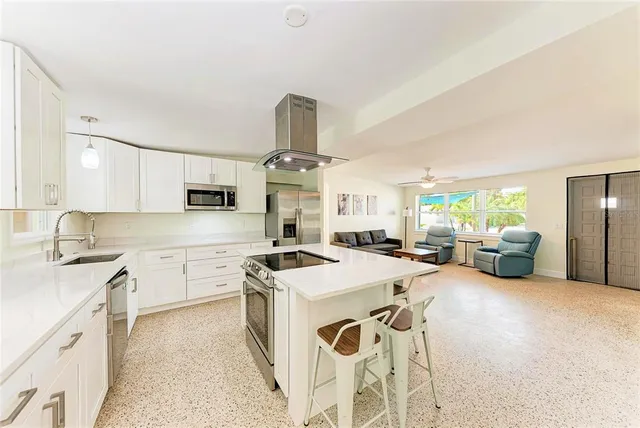 a kitchen with stove a sink and cabinets