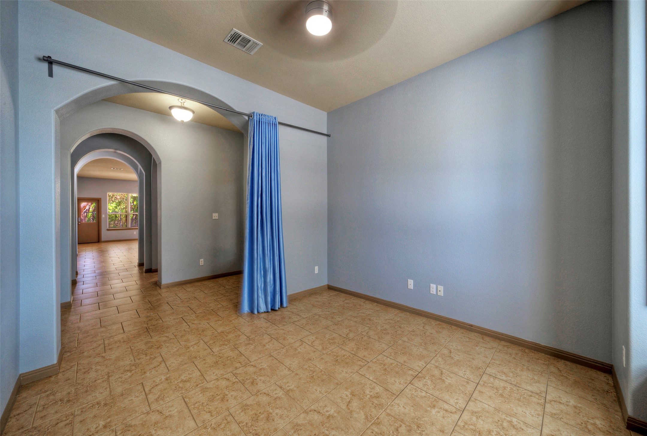 1601 Nelson Ranch Loop Cedar Park, TX 78613 - Photo 9 of 30 A long hallway of arched entries extends from this tiled bonus room.