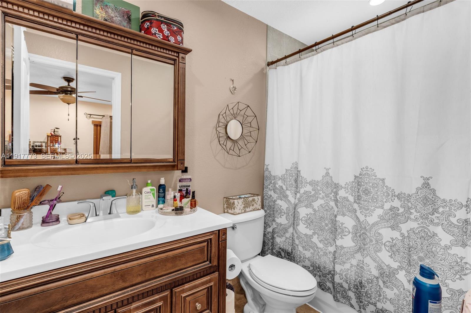 11347 Southwest 246th Terrace Homestead, FL 33032 - Photo 15 of 40 a bathroom with a sink a toilet and a mirror