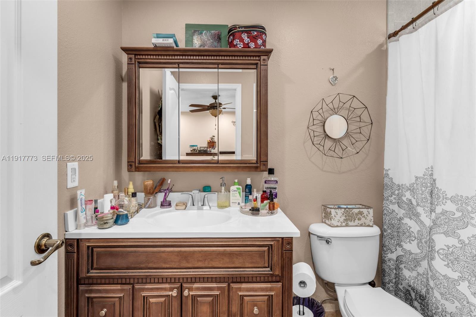 11347 Southwest 246th Terrace Homestead, FL 33032 - Photo 16 of 40 a bathroom with a toilet sink and mirror