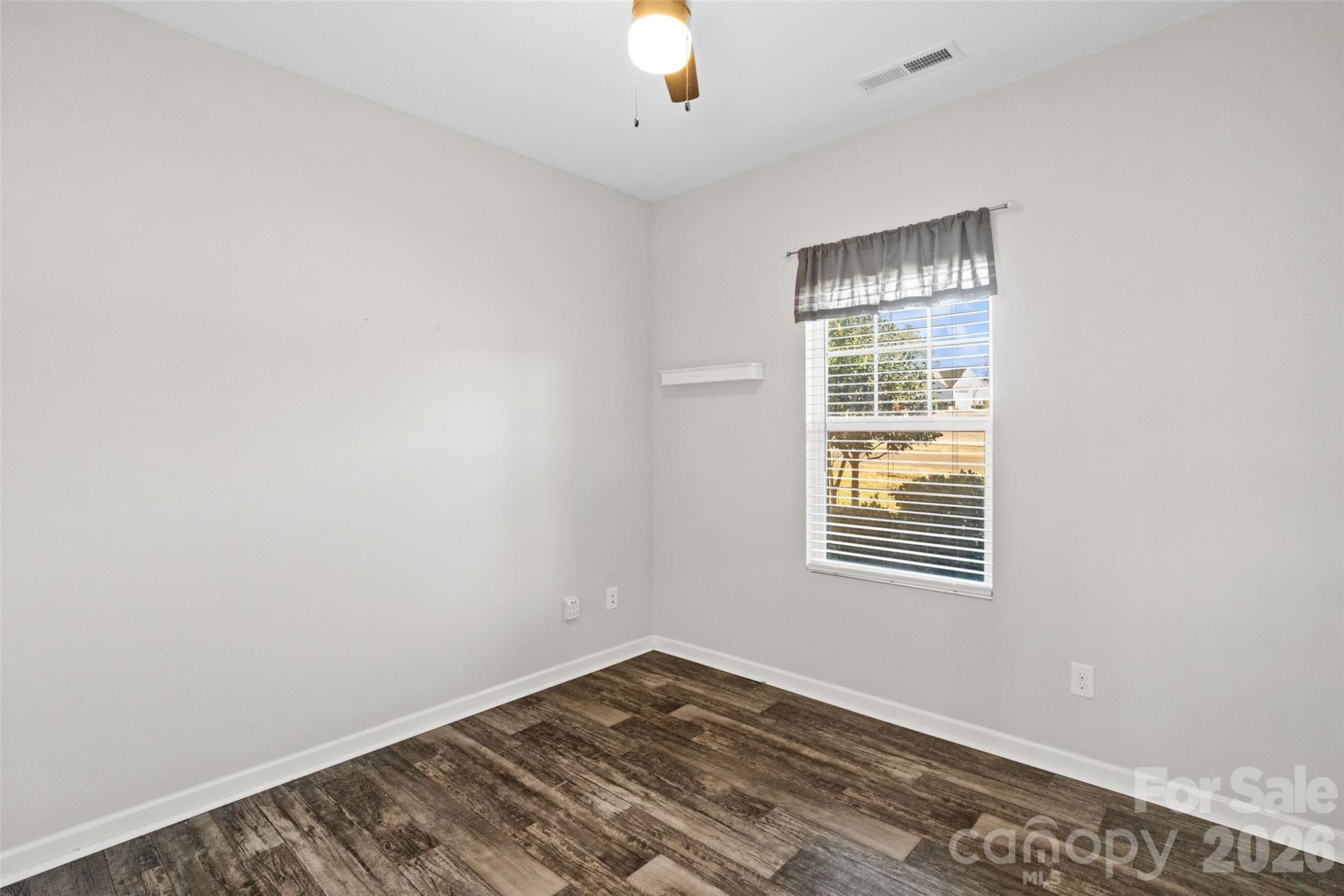 21260 Sanctuary Drive Lancaster, SC 29720 - Photo 17 of 44 a view of an empty room with wooden floor and a window