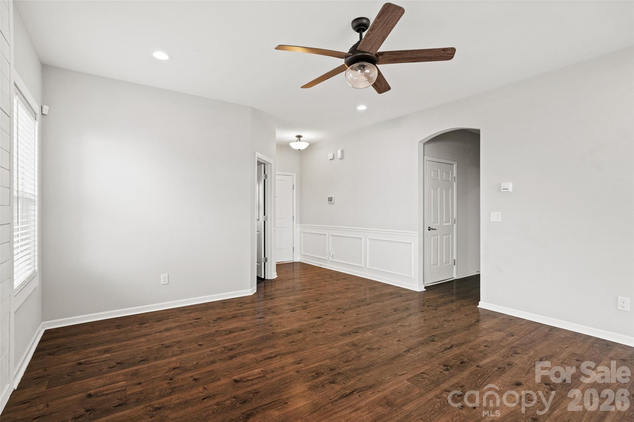 21260 Sanctuary Drive Lancaster, SC 29720 - Photo 19 of 44 a view of an empty room with wooden floor and a ceiling fan