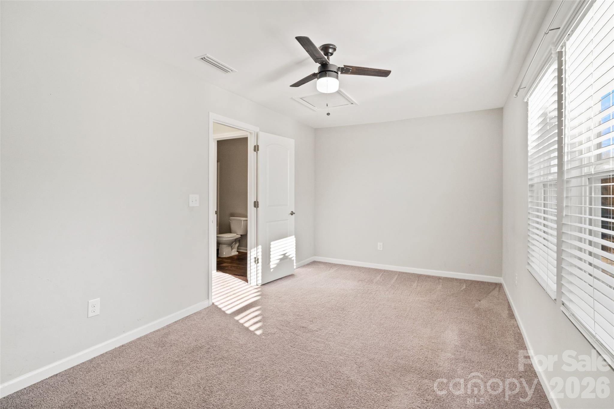 21260 Sanctuary Drive Lancaster, SC 29720 - Photo 29 of 44 an empty room with a ceiling fan and window