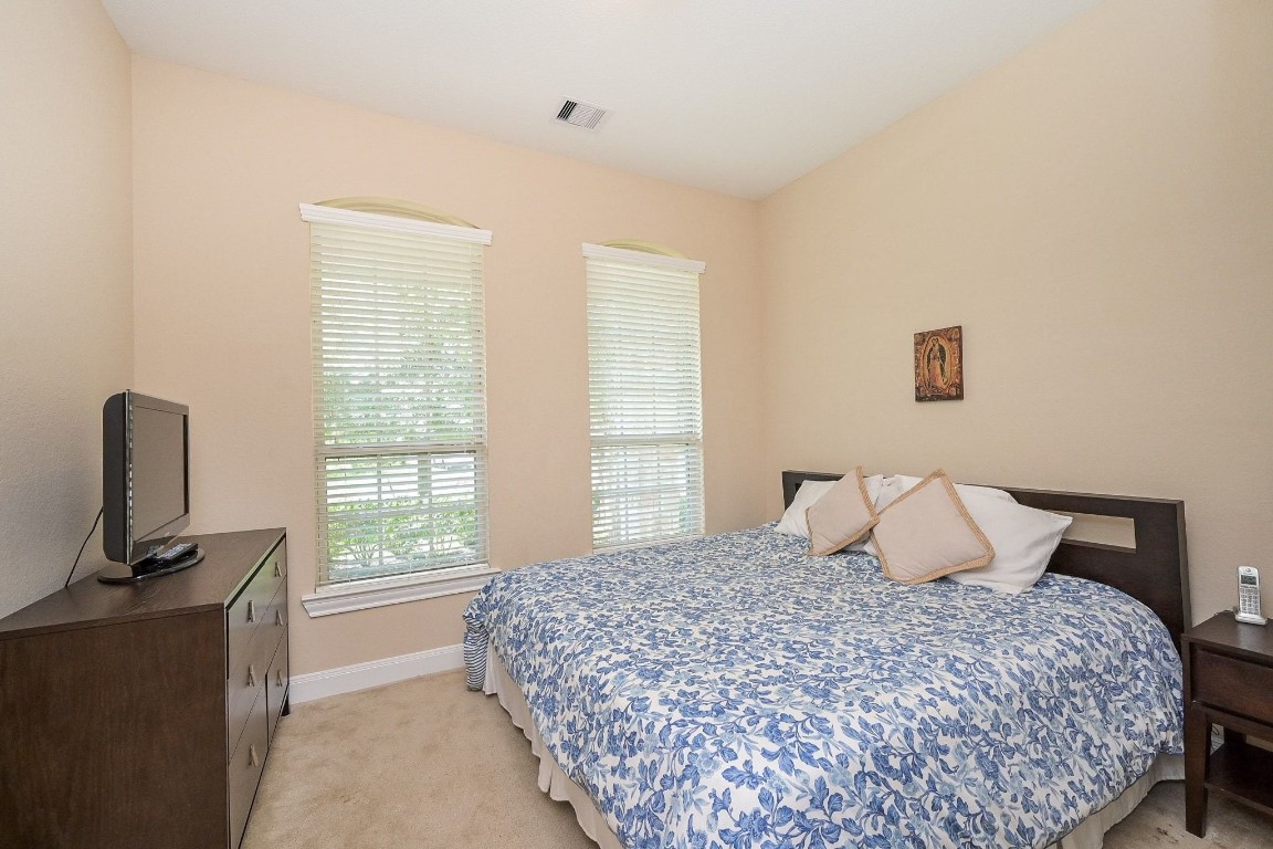 107 North Bacopa Drive Spring, TX 77389 - Photo 26 of 34 Bright bedroom with two tall windows that bring in natural light, creating a peaceful and inviting space.