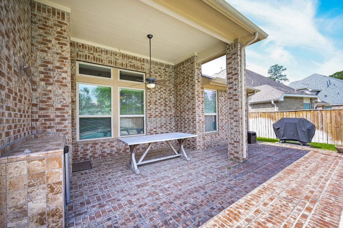 107 North Bacopa Drive Spring, TX 77389 - Photo 29 of 34 Covered patio with plenty of room for outdoor dining or relaxing, overlooking the backyard.