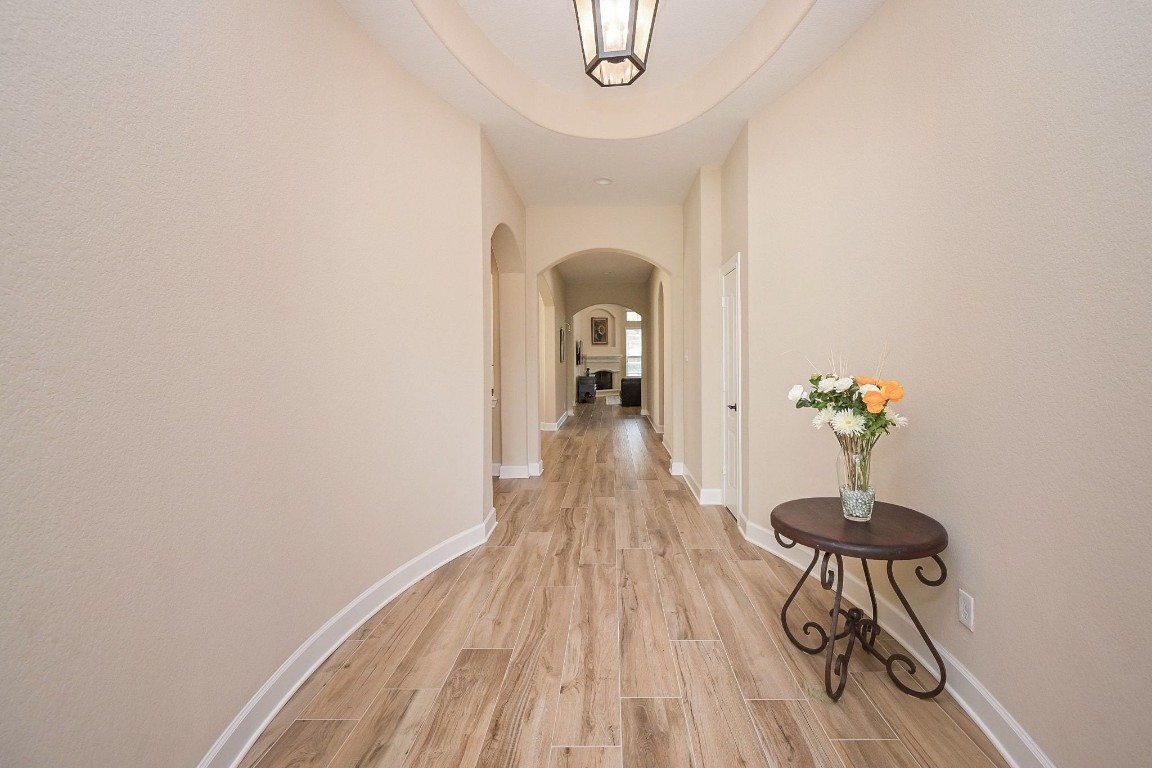 107 North Bacopa Drive Spring, TX 77389 - Photo 4 of 34 Bright entry hallway with high ceilings and soft natural light, leading seamlessly into the main living areas.