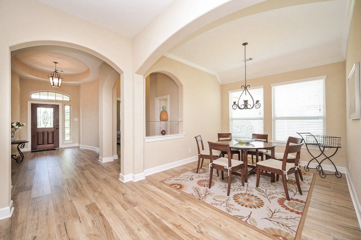107 North Bacopa Drive Spring, TX 77389 - Photo 5 of 34 Long, open hallway with elegant archways and high ceilings, creating a smooth flow toward the heart of the home.