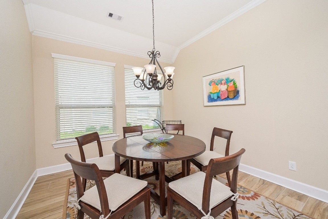 107 North Bacopa Drive Spring, TX 77389 - Photo 6 of 34 Bright dining space with large windows that fill the room with natural light and a tray ceiling that adds an open, airy feel.