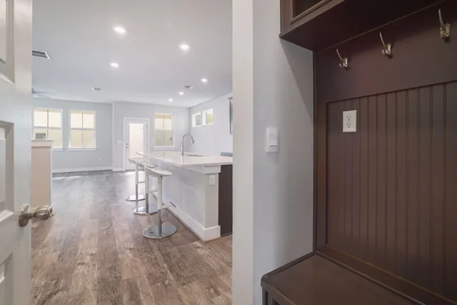 a view of a room with wooden floor and a window