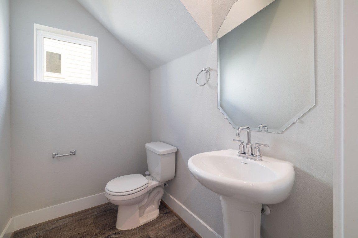 7607 Eckington Street, Unit 235 Austin, TX 78744 - Photo 12 of 37 a bathroom with a toilet sink and mirror