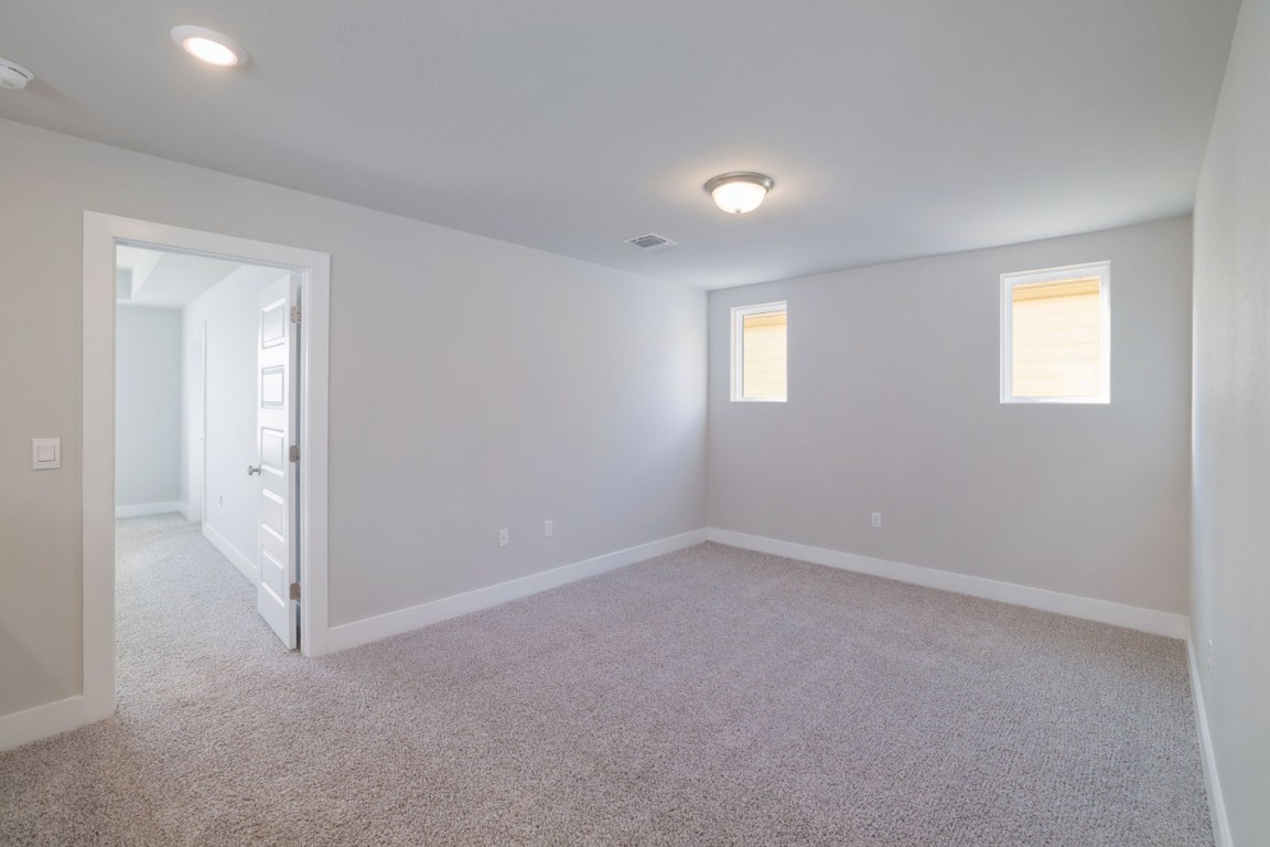 7607 Eckington Street, Unit 235 Austin, TX 78744 - Photo 14 of 37 an empty room with windows and closet