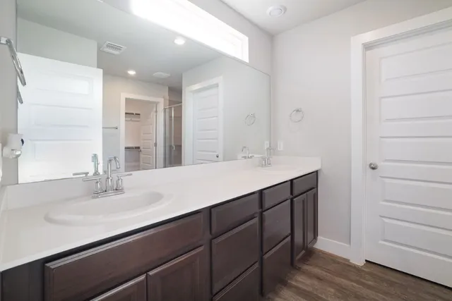 a bathroom with a sink double vanity and a mirror