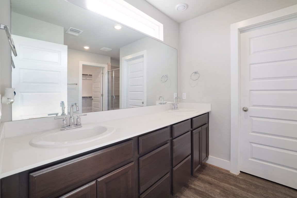 7607 Eckington Street, Unit 235 Austin, TX 78744 - Photo 18 of 37 a bathroom with a sink double vanity and a mirror