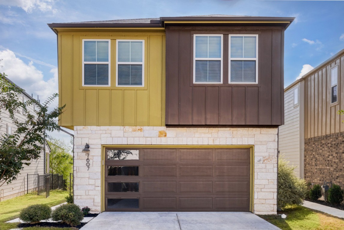 7607 Eckington Street, Unit 235 Austin, TX 78744 - Photo 2 of 37 a front view of a house with a garden