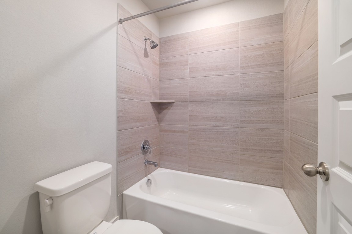 7607 Eckington Street, Unit 235 Austin, TX 78744 - Photo 24 of 37 a white bath tub sitting next to a white toilet and sink