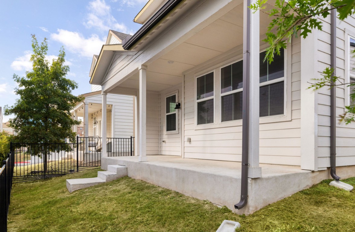 7607 Eckington Street, Unit 235 Austin, TX 78744 - Photo 27 of 37 a front view of a house with a yard