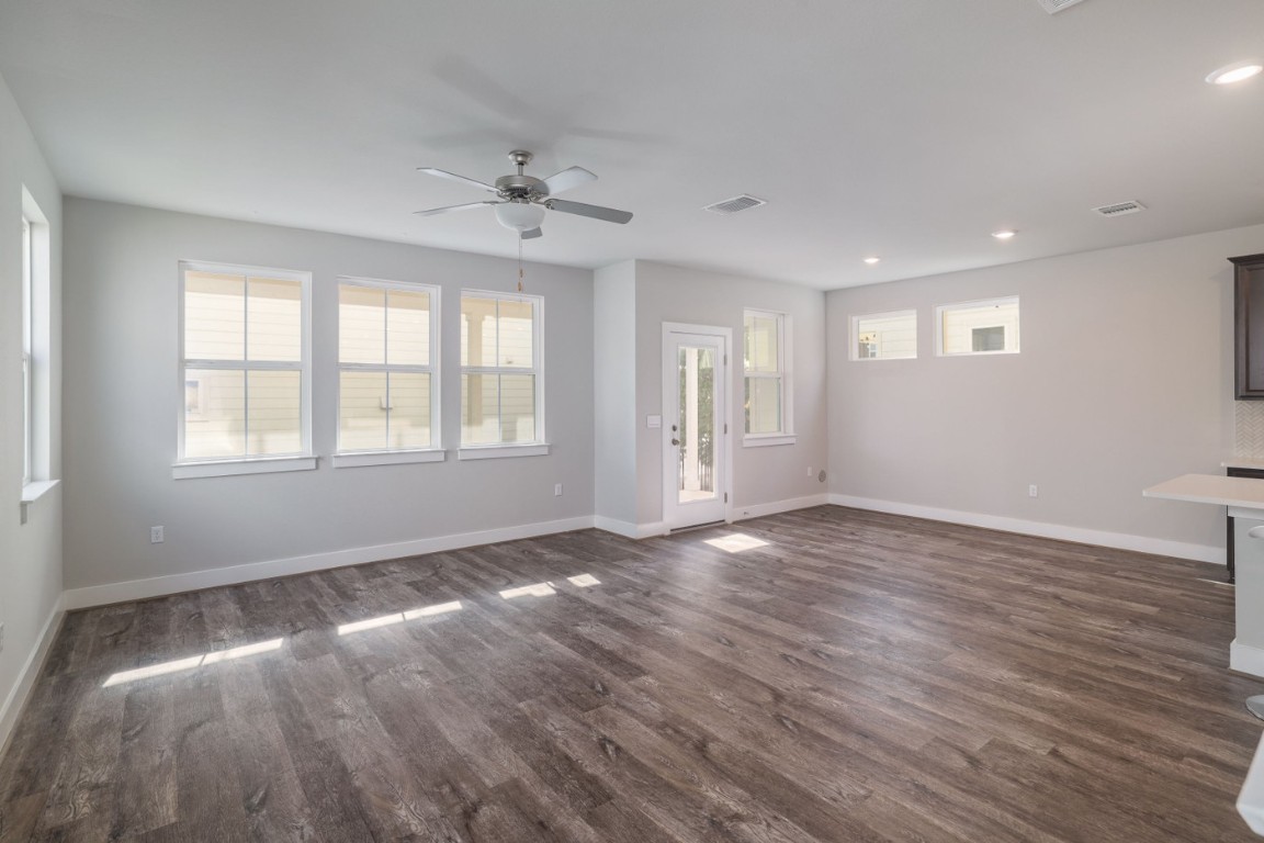 7607 Eckington Street, Unit 235 Austin, TX 78744 - Photo 4 of 37 a view of an empty room with wooden floor and a window