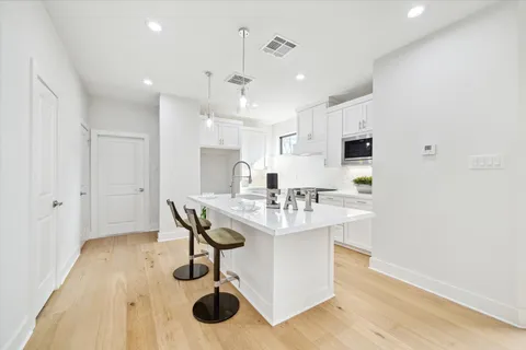 a kitchen with kitchen island a sink stainless steel appliances and cabinets
