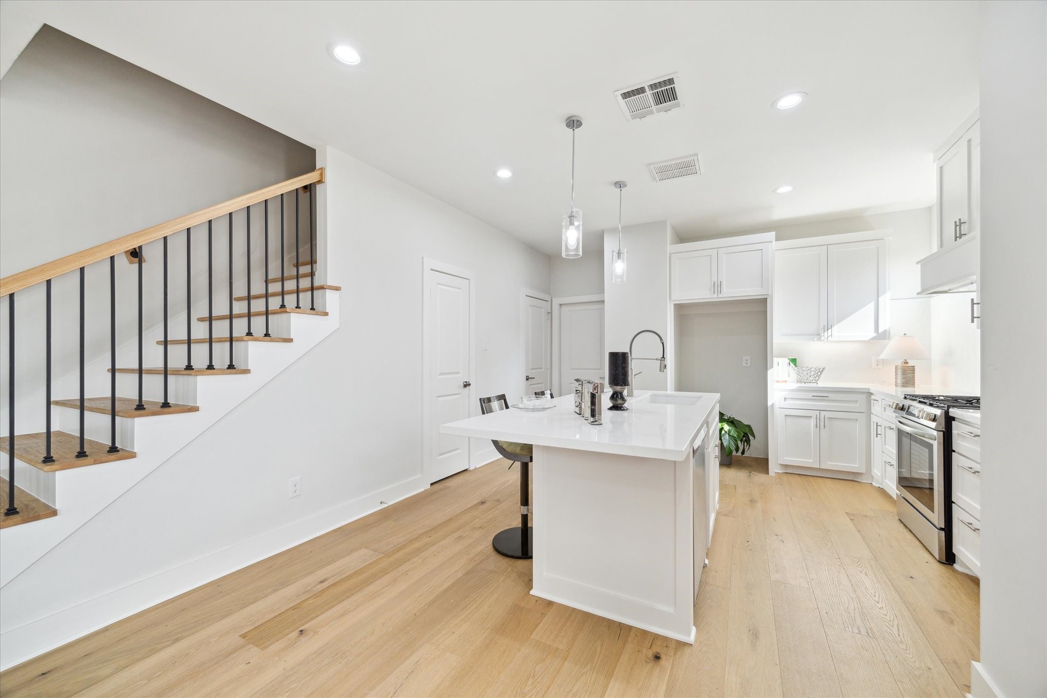 2207 Stevens Street Houston, TX 77026 - Photo 5 of 30 a kitchen with stainless steel appliances kitchen island hardwood floor sink and stove