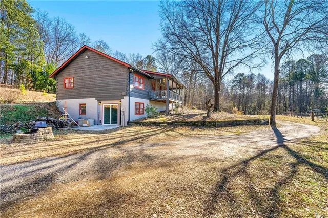 a bedroom with a bed and a flat tv screen on dresser