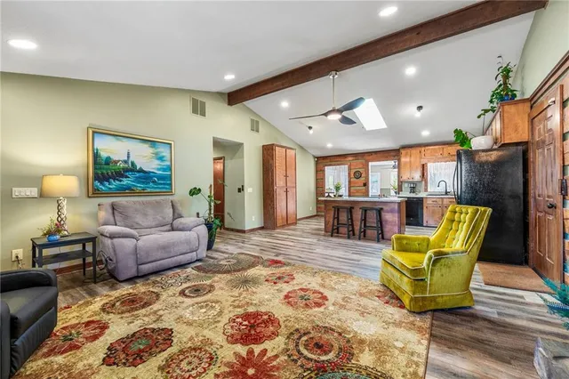 a view of an empty room with a window and fireplace