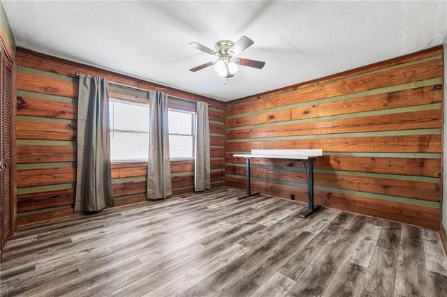 a backyard of a house with large trees and outdoor space