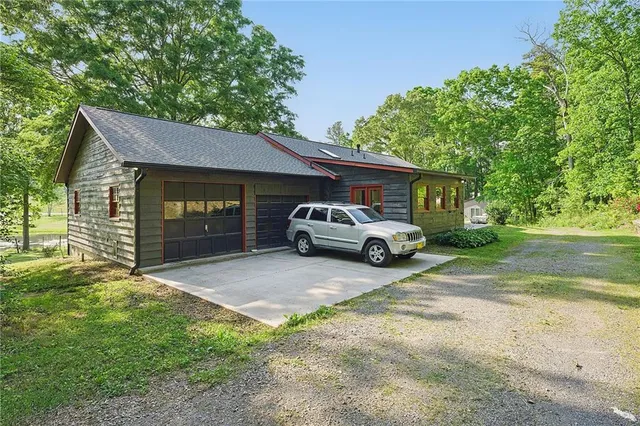 a kitchen with stainless steel appliances granite countertop a stove a refrigerator a oven a sink with island and chairs