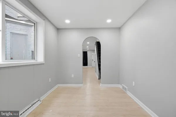 a view of a room with wooden floor and windows
