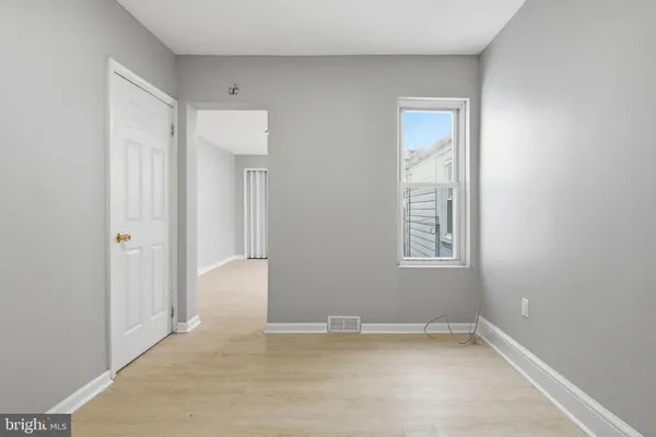 an empty room with windows and closet