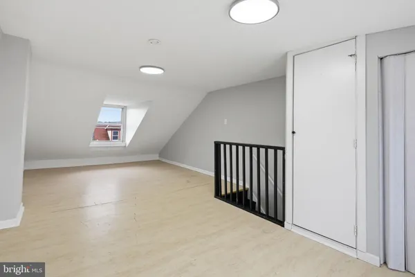 an empty room with windows and closet