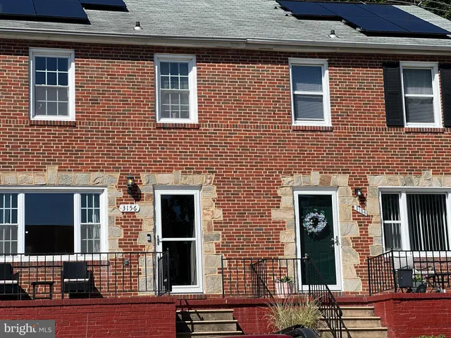 a front view of a house with many windows