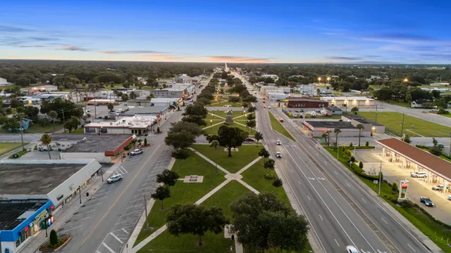 a view of swimming pool with a table and chair under an umbrella