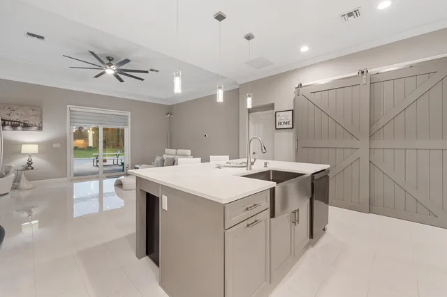 a kitchen with a sink a stove a refrigerator and island