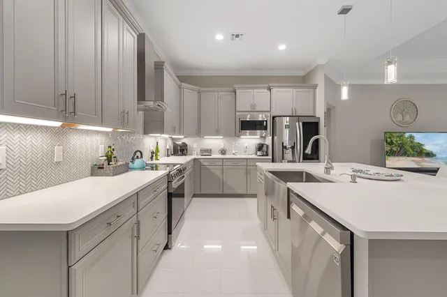 a kitchen with kitchen island white cabinets and white appliances
