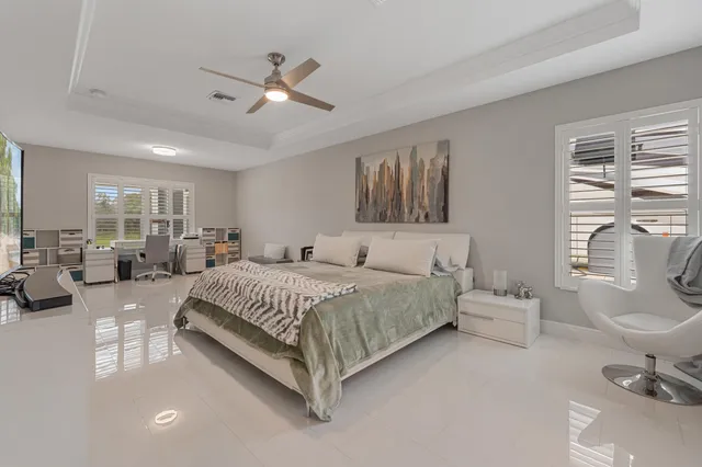a spacious bedroom with a bed couch and a window