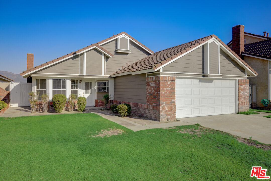 214 South Raspberry Lane Anaheim, CA 92808 - Photo 13 of 35 a front view of a house with a yard