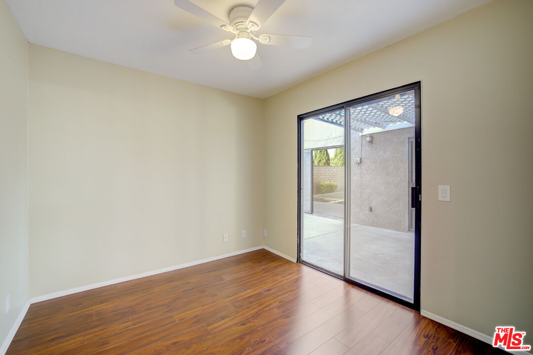 214 South Raspberry Lane Anaheim, CA 92808 - Photo 25 of 35 an empty room with wooden floor and fan