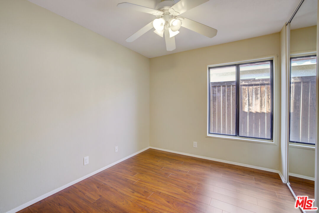 214 South Raspberry Lane Anaheim, CA 92808 - Photo 29 of 35 an empty room with wooden floor and windows
