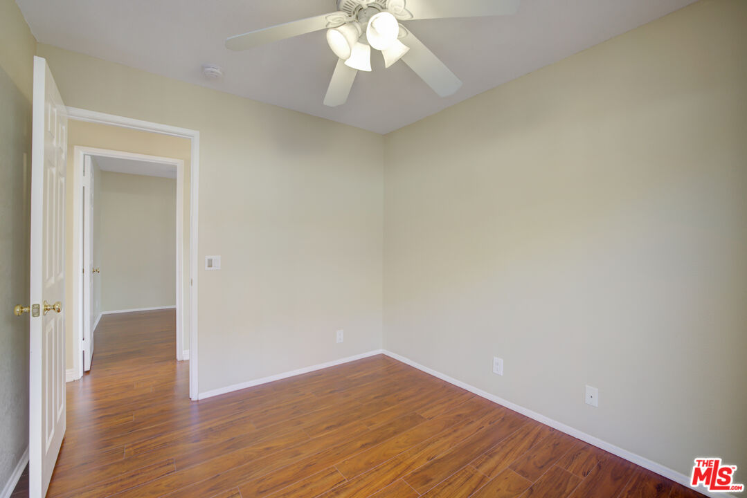 214 South Raspberry Lane Anaheim, CA 92808 - Photo 30 of 35 a view of empty room with wooden floor and fan