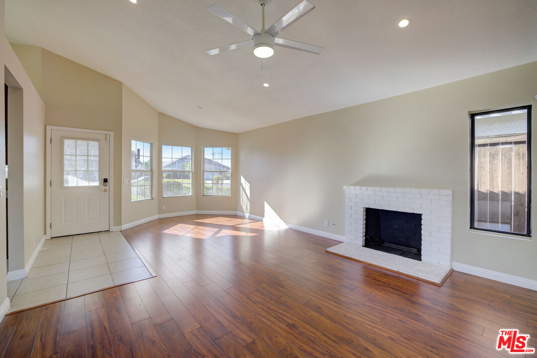 214 South Raspberry Lane Anaheim, CA 92808 - Photo 5 of 35 a view of an empty room with window and wooden floor
