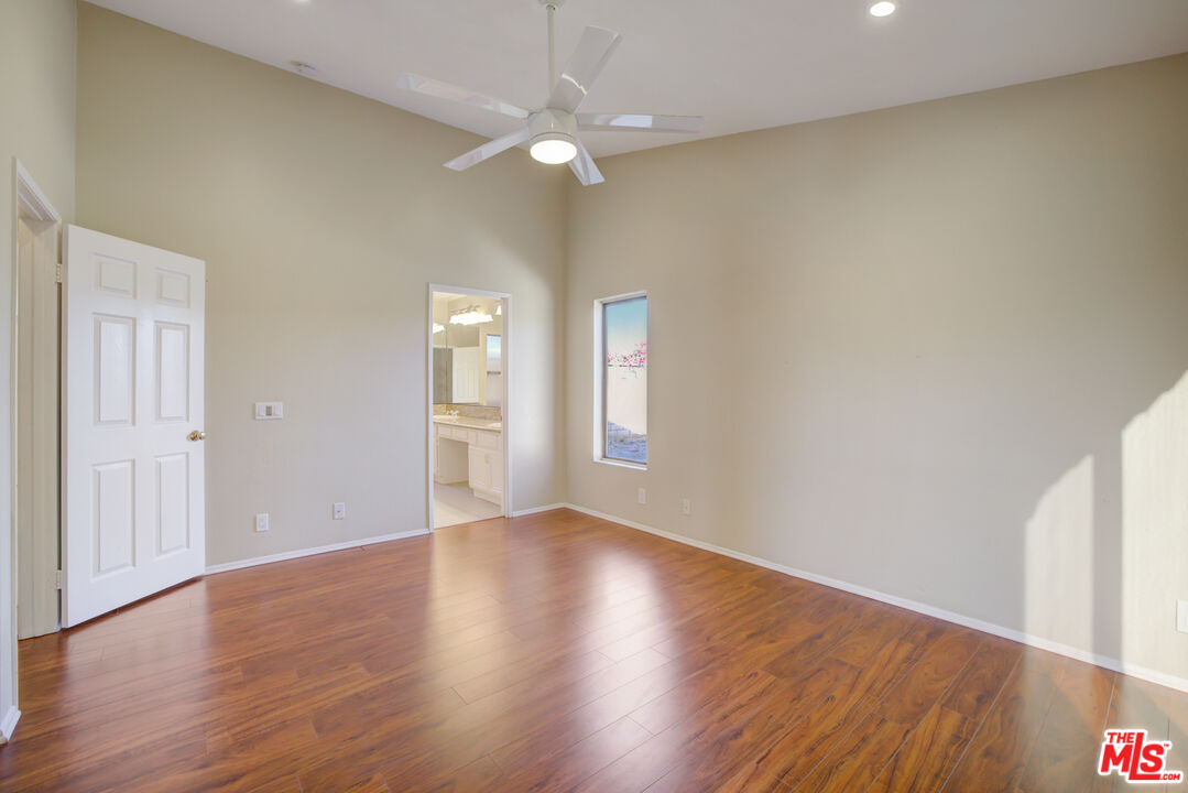 214 South Raspberry Lane Anaheim, CA 92808 - Photo 10 of 35 a view of an empty room with window and wooden floor