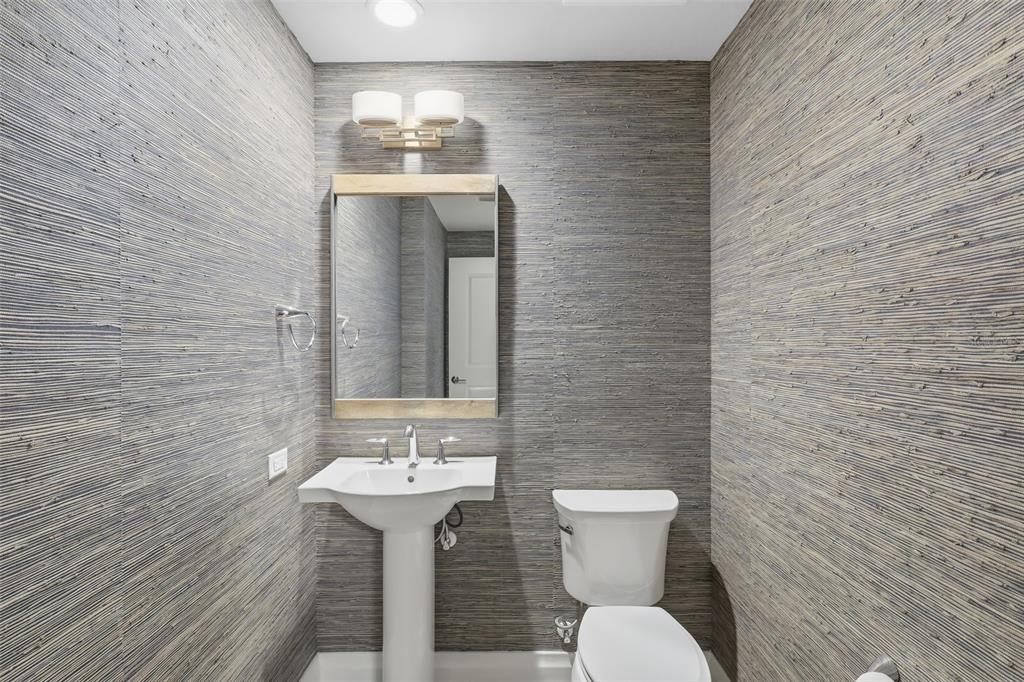 800 Collany Road, Unit 302 St. Petersburg, FL 33715 - Photo 34 of 66 a bathroom with a sink a toilet and mirror