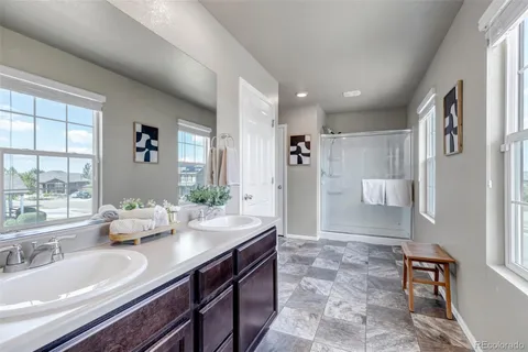 a spacious bathroom with a tub sink and mirror