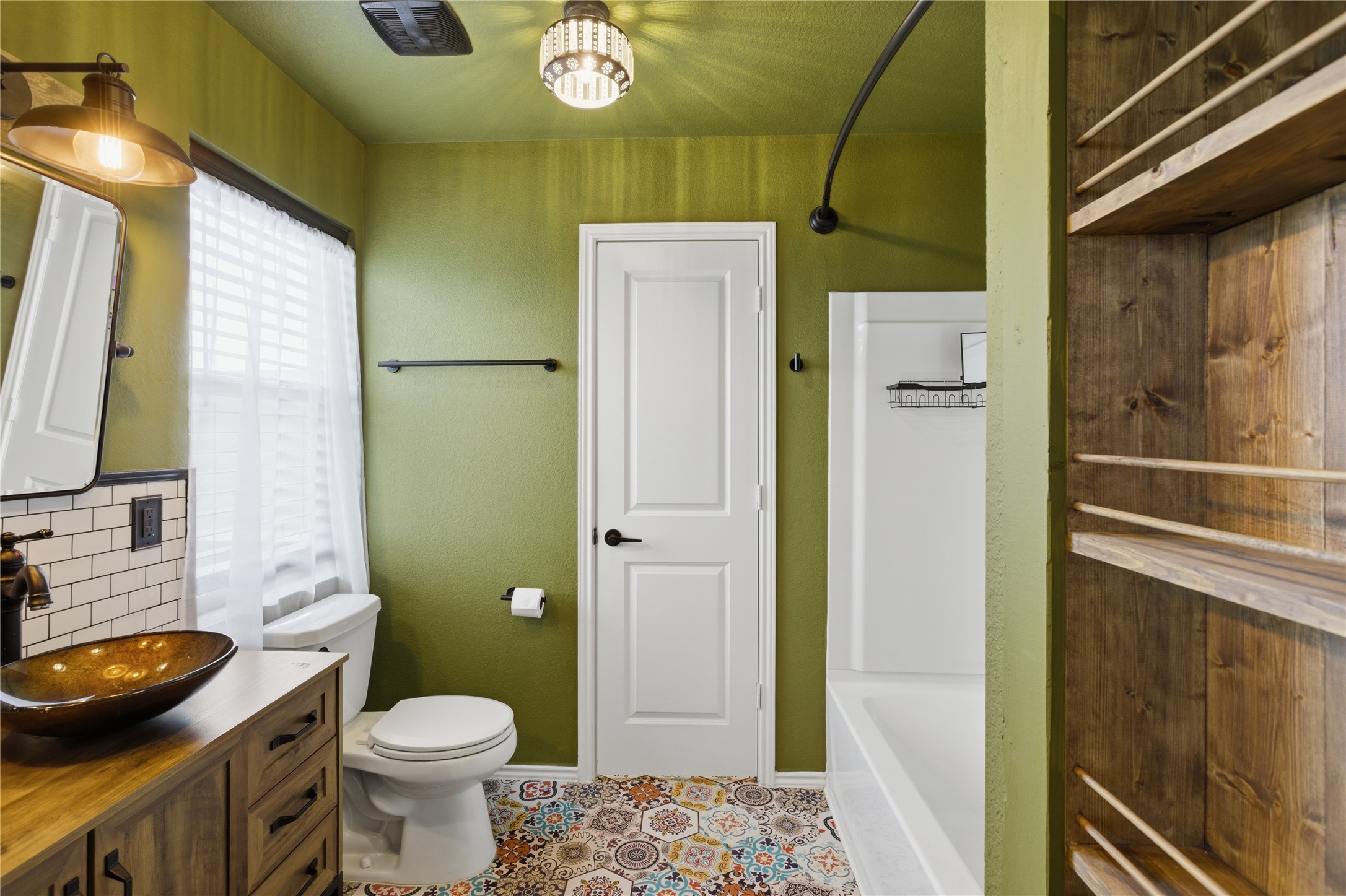 116 Night Riders Way Jarrell, TX 76537 - Photo 24 of 40 Primary Bathroom featuring a unique patterned floor tile, a freestanding vanity with a vessel sink, and an integrated bathtub with shower
